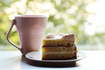 Pink cup of tea and piece of cake