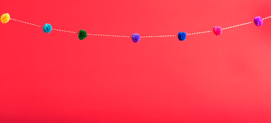 Red background with decorative pom pom border