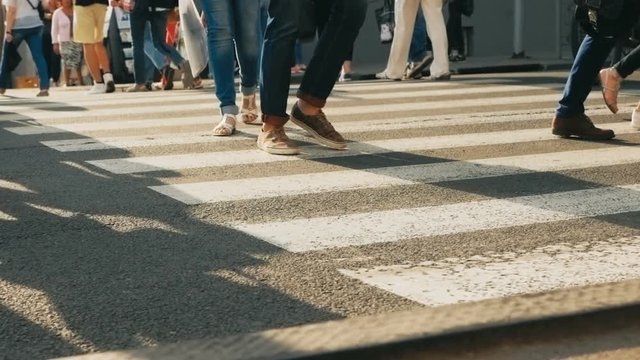 SLOW MOTION: People crossing street. Crowded crosswalk. City life. Peak hour.