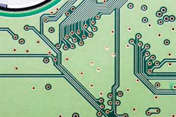 Pattern of electronic part of computer on green board in close up