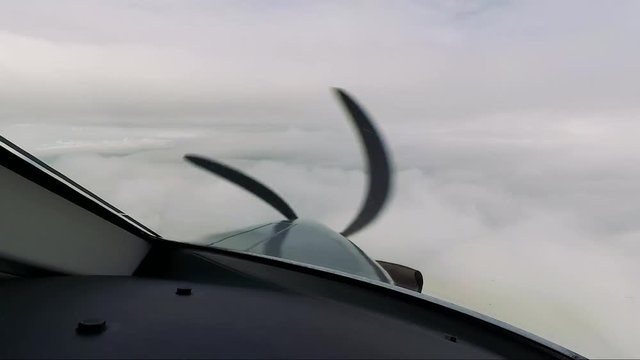A private plane flies through the clouds - a view from the cockpit