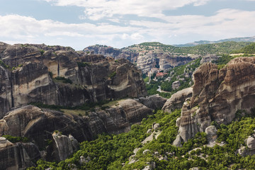 Fototapeta na wymiar Rock formations in the Meteora and view to and the Holy Monastery of Roussanou, Great Meteoron and Varlaam, UNESCO World Heritage Site, Trikala, Greece