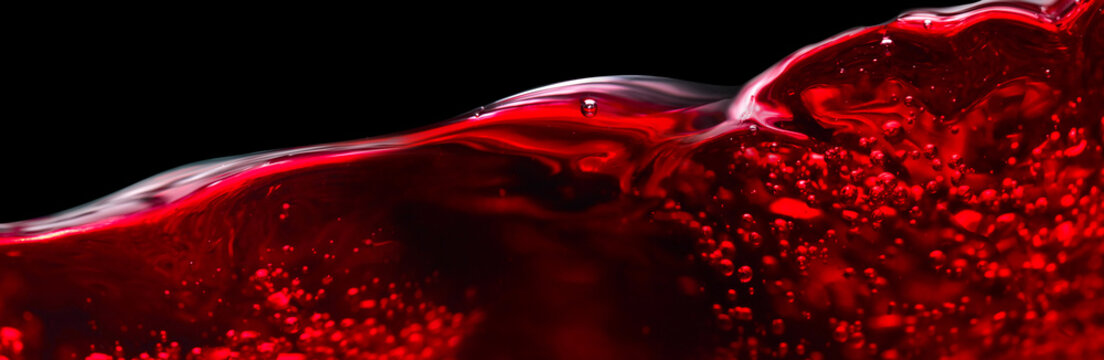Red wine isolated on black background