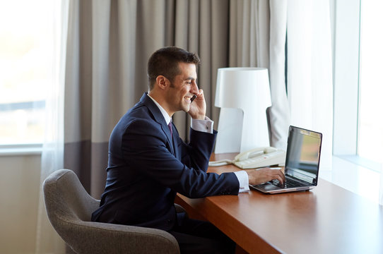 businessman with laptop and smartphone at hotel
