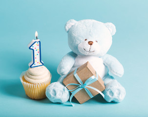 Child's first birthday celebration theme with cupcakes and stuffed animal