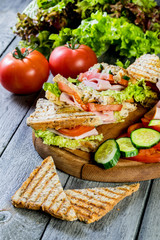 Panini sandwich with ham, tomato and lettuce.