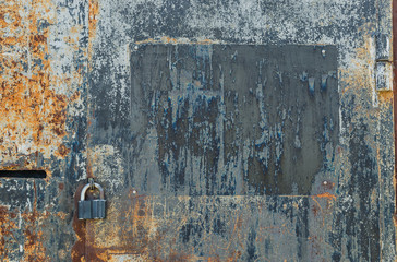 Old padlock on rusty gate