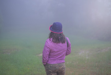 Cute girl in the middle of a foggy haze.