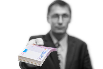 The man gives out a bundle of notes 500 euros. Shallow focus. Isolated on white.