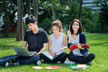 Young Student Asian Group Teenager with school folders on grass at university campus college