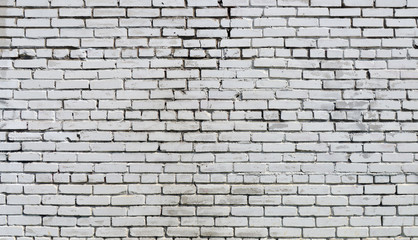 Brick wall painted with white paint.