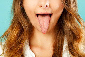 close up of healthy woman tongue over blue background © Sunny