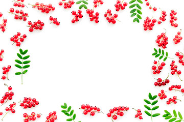 Berry frame. Red currant and leaves on white background top view copyspace