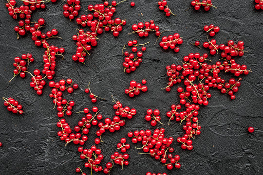 Berry theme. Red currant on black table background top view