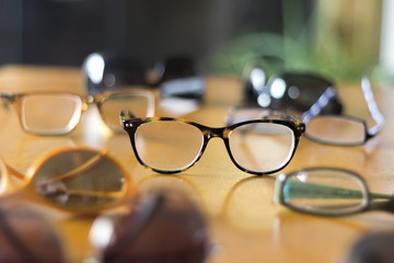 Stylish Eyeglasses on Table - obrazy, fototapety, plakaty