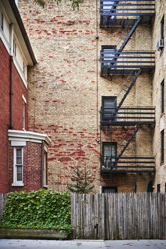 Fire Escapes On The Side Of A Brownstone Apartment Building