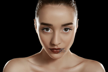 Beautiful young woman with lips makeup on dark background