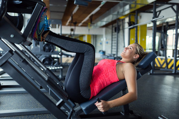 Fototapeta na wymiar Woman doing exercises in gym for legs