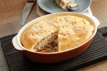 Baking dish with turkey pot pie on table