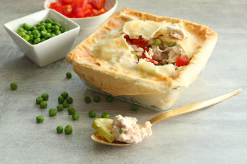 Baking dish with turkey pot pie on light gray background