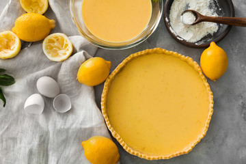 Uncooked lemon pie and ingredients on table