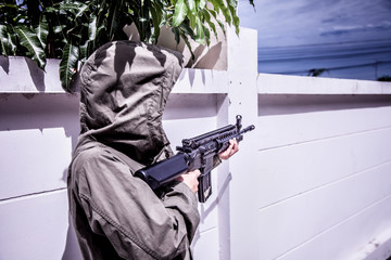 Gunner terrorists half face and eyes contact with masked and machine gun or rifles sniper shooting...