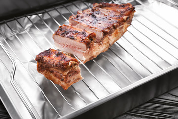 Baking tray with delicious pork ribs, closeup