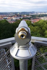 Public telescope with Prague city center in background, Czech republic