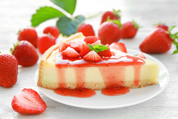 Piece of homemade strawberry cake poured with syrup on plate
