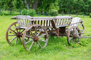 Fototapeta na wymiar wooden cart on a meadow on a summer day