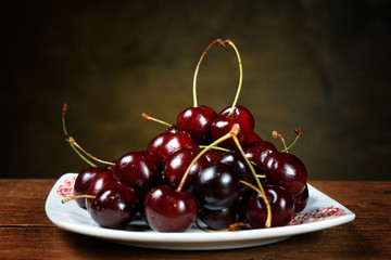Cherry in a plate on a rural table