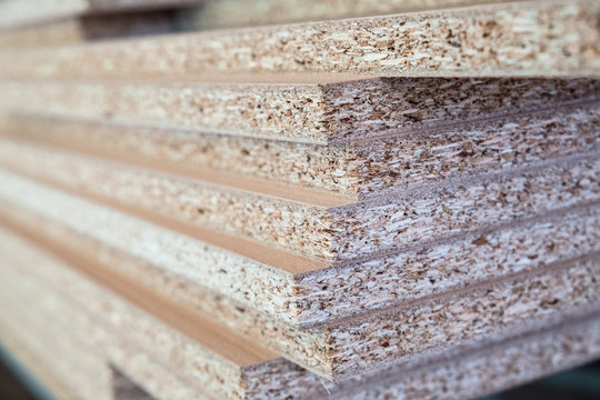 Chipboard pieces stacked in the workshop. Woodworking, carpentry, production
