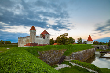 Fototapeta premium Colorful sunrise over Kuressaare castle, summer time. Saaremaa island, Estonia