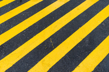 Fototapeta premium Asphalt Background with diagonal black and yellow warning stripes