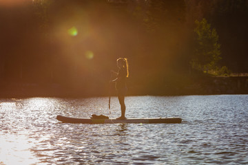 Paddle boarding at sunrise on a mountain lake