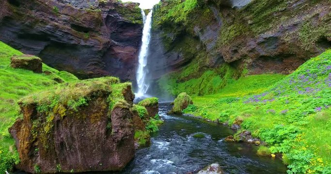 Traversing Shot Of Ribbon Waterfall In Green Canyon With River - Aerial Footage of the Kvernufoss Falls in Iceland