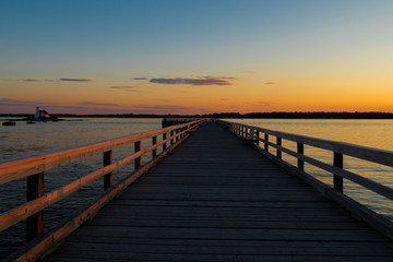 Fototapeta na wymiar Walkway of a bridge at sunset andamanbangkokbaybeachbridgecolorfuldaydramaticduskharborhorizonislandlagoonlakelandscapemainemaldivesmarinamorningmotorboatnaturenew hampshirenightoceanoverparadisepier