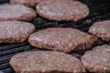 Close up of hamburger patties on grill