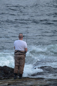 A man fishing in a high tide