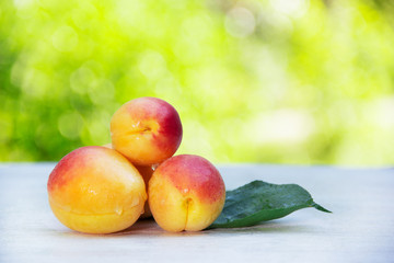 Juicy ripe apricots on a white table. Summer fruits. Copy space