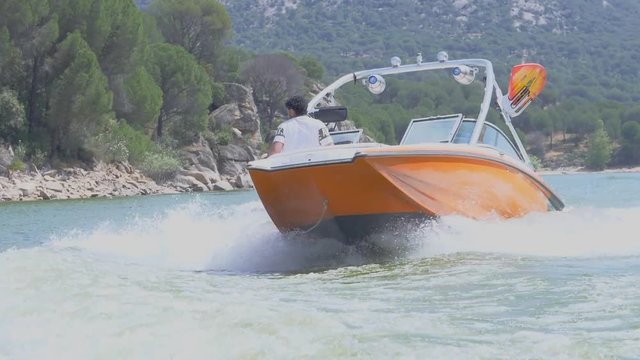Front orange boat wakeboarding at high speed. Slow motion 2