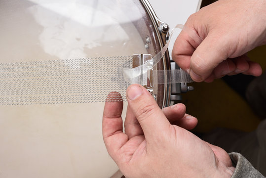 Master Hands Fixing Wire On Snare Drum