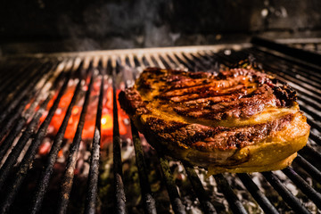 Tuscan steak on a griddle with red charcoal