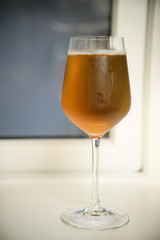 Selective focus of Glass of soft drink with soft and warm light, Cold sparkling wine in clear glass for dinner