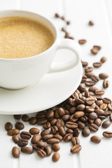 Hot coffee cappuccino and coffee beans.