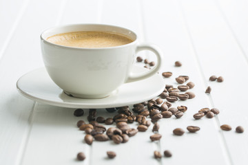 Hot coffee cappuccino and coffee beans.