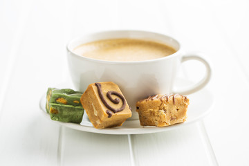 Colorful caramel candies and coffee cup.