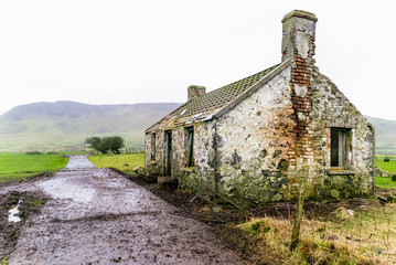An old abandoned Irish farmhouse at the foot of Sallagh Brae, County Antrim, Northern Ireland.