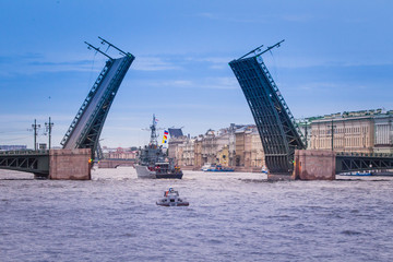 Fototapeta na wymiar St. Petersburg Palace Bridge. Military ship passes under the Palace Bridge. Neva River.