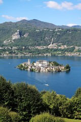 Fototapeta na wymiar Viewpoint from Sacro Monte to Lake Orta and Isola San Giulio in summer, Piedmont Italy 